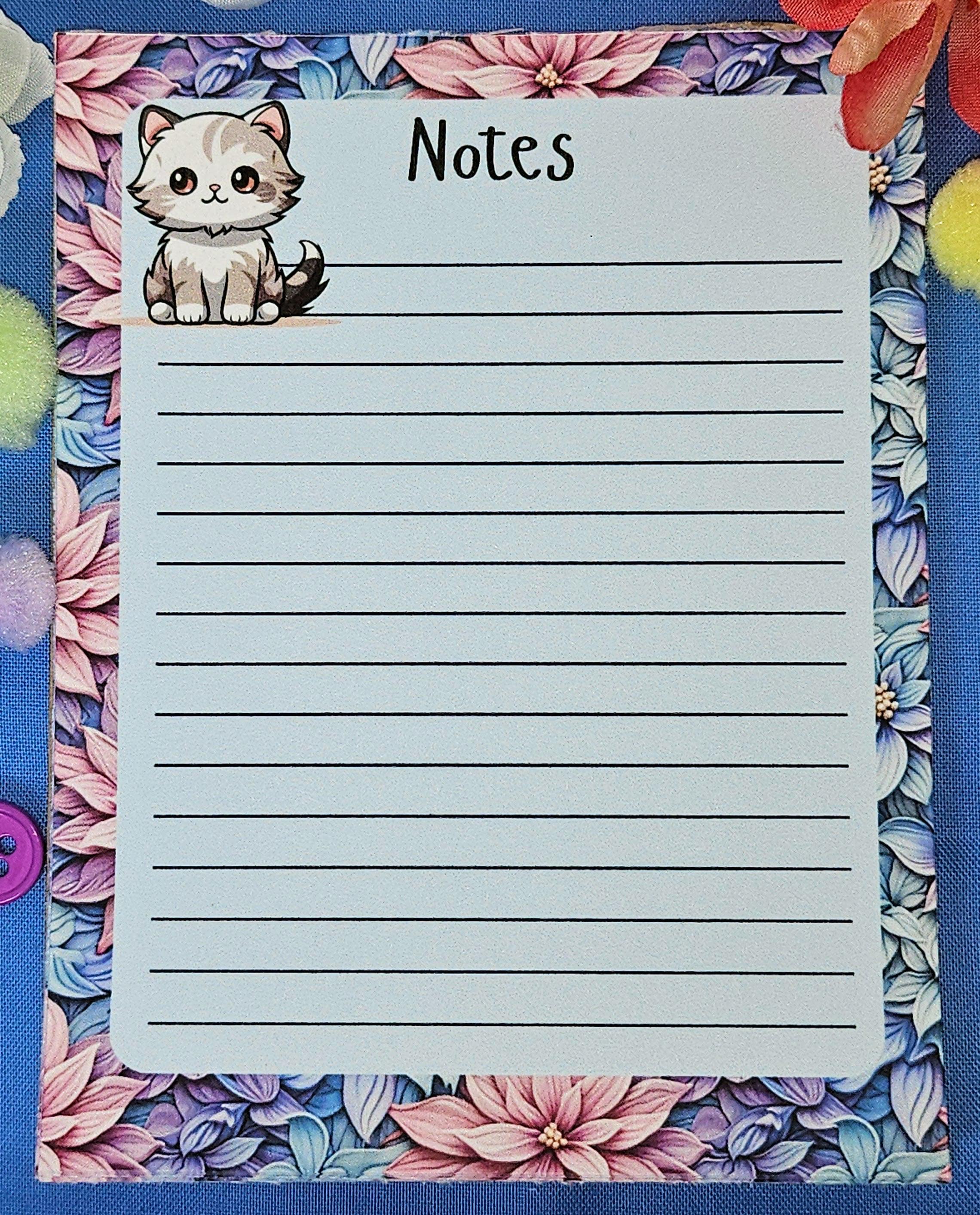 Cute cat notepad with pastel floral border for note taking and journaling.