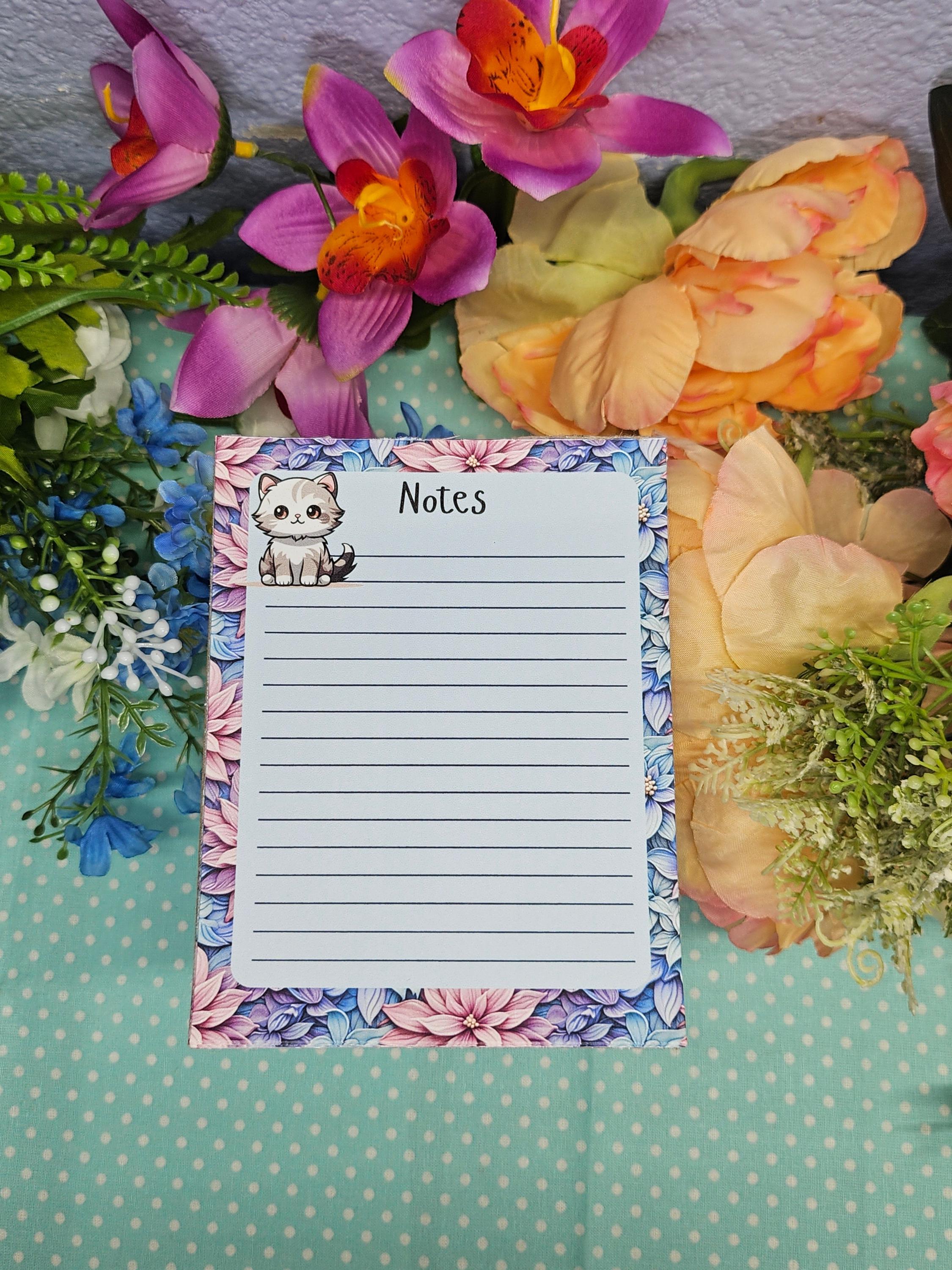 Cute cat notepad with pastel floral border for note taking and journaling.