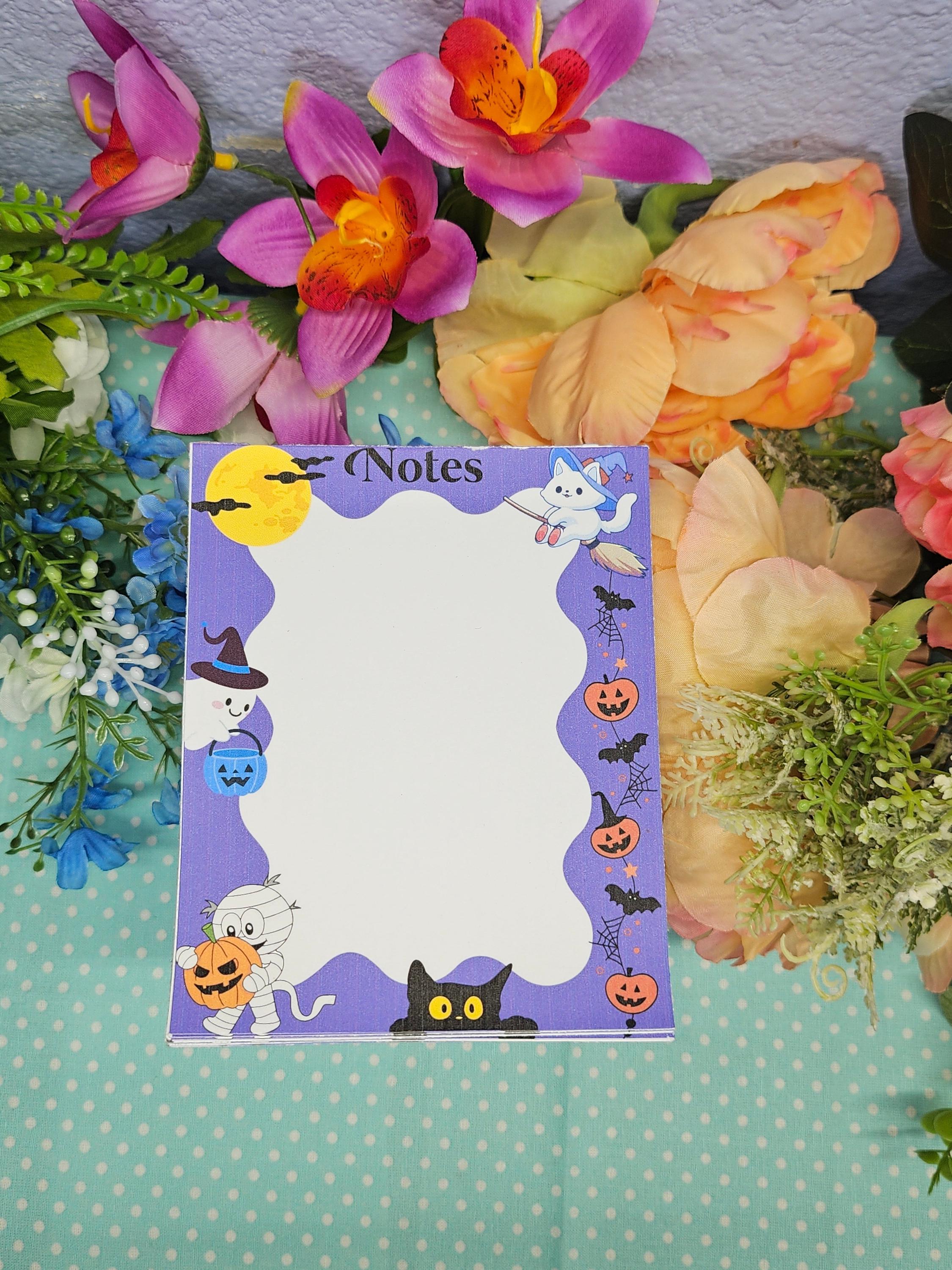 Cute Halloween notepad with ghosts, cats, pumpkins, and bats for fall journaling and notes.