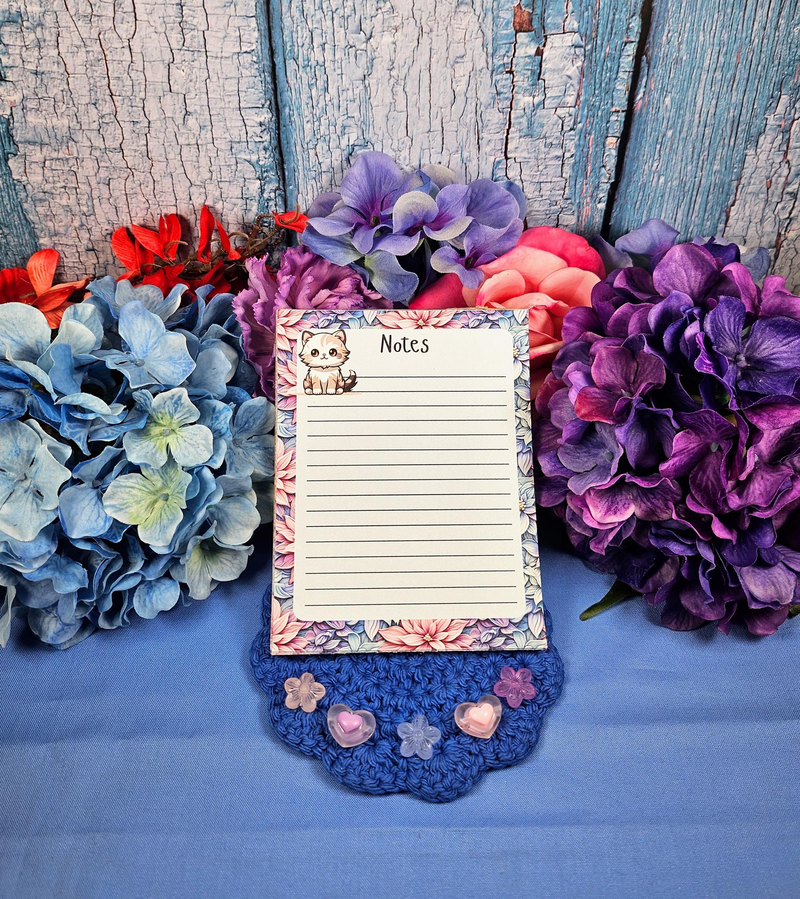 Cute cat notepad with pastel floral border for note taking and journaling.