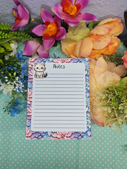 Cute cat notepad with pastel floral border for note taking and journaling.